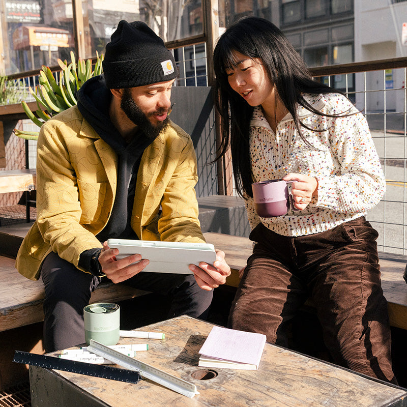 12oz-rise-mug-e0 12oz_rise_coffee_mug_dusty_orchid_couple_city_patio_square.jpg