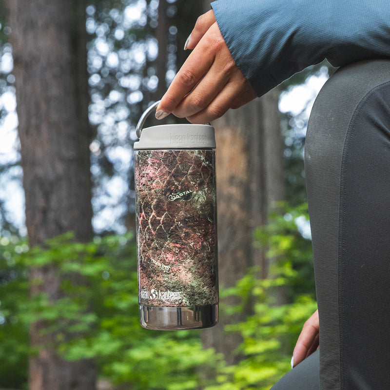 12oz-tkwide-with-cafe-cap-mossy-oak-t3 12oz_tumbler_mossyoak_rainbowtrout_hand_closeup_square.jpg