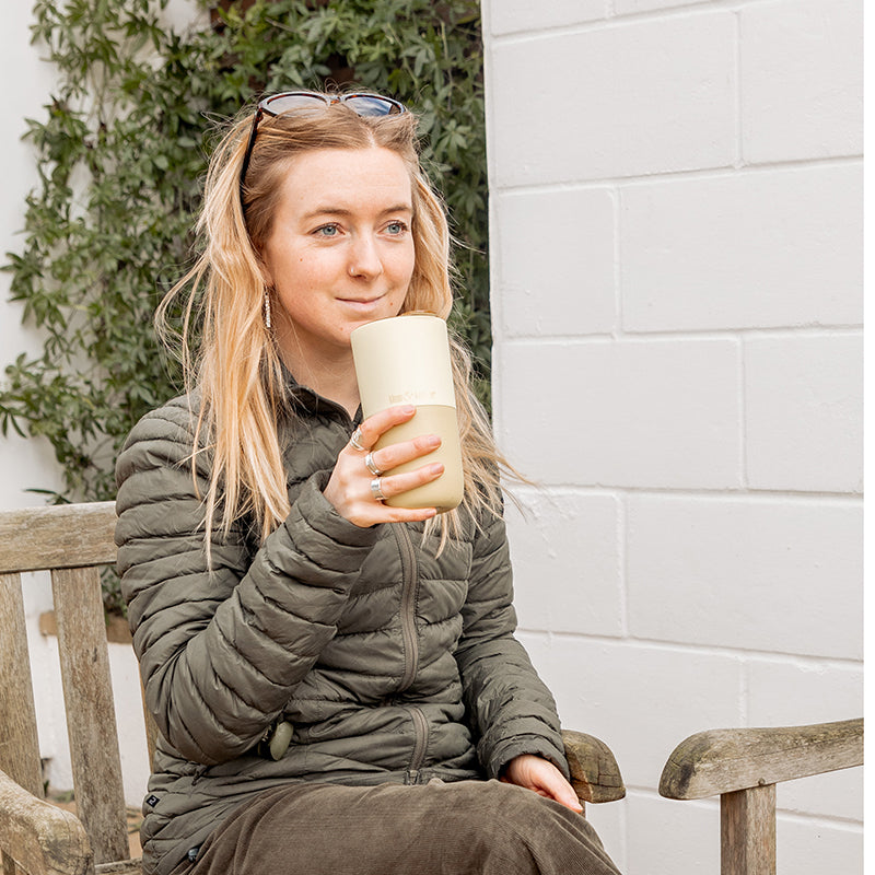 16oz-rise-tumbler-n2 16oz_rise_tumbler_wax_yellow_woman_seat_outside_square.jpg