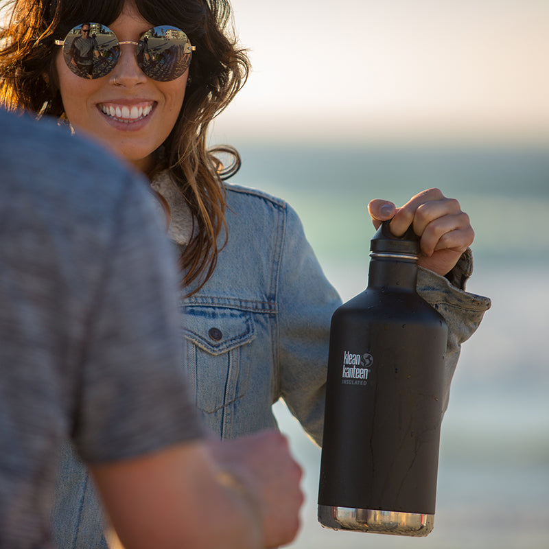 64oz-classic-with-loop-cap-q1 64oz_insulated_classic_black_beach_girl_hand_square.jpg