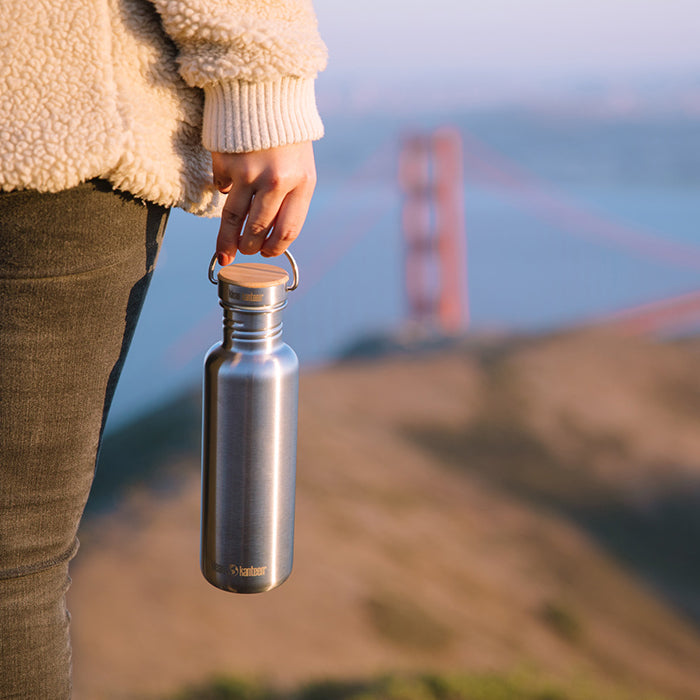27oz-reflect-with-bamboo-cap-b4 K27SSLRF-BS-BAMBOO_reflect_bottle_bridge_lifestyle.jpg