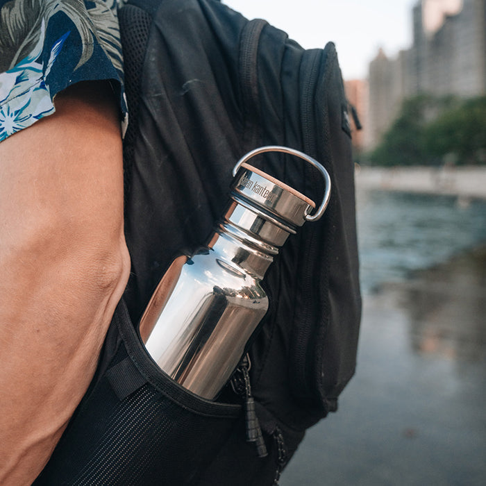 27oz-reflect-with-bamboo-cap-b4 K27SSLRF-MS-BAMBOO_reflect-bottle_backpack_lifestyle.jpg
